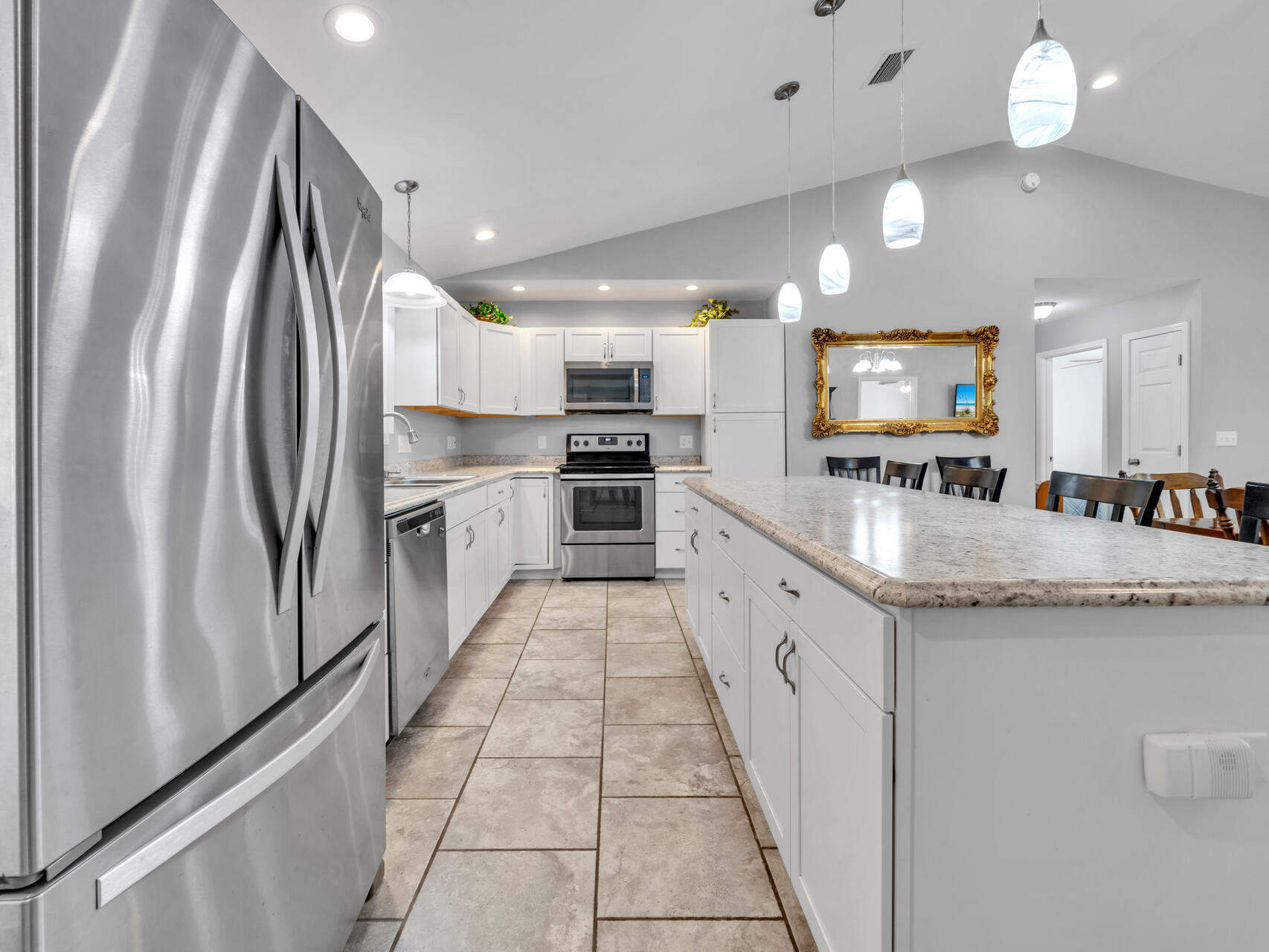 5346 Fox Hound Lane Baker, FL 32531 - Photo 16 of 46 a large kitchen with a large counter top appliances and cabinets