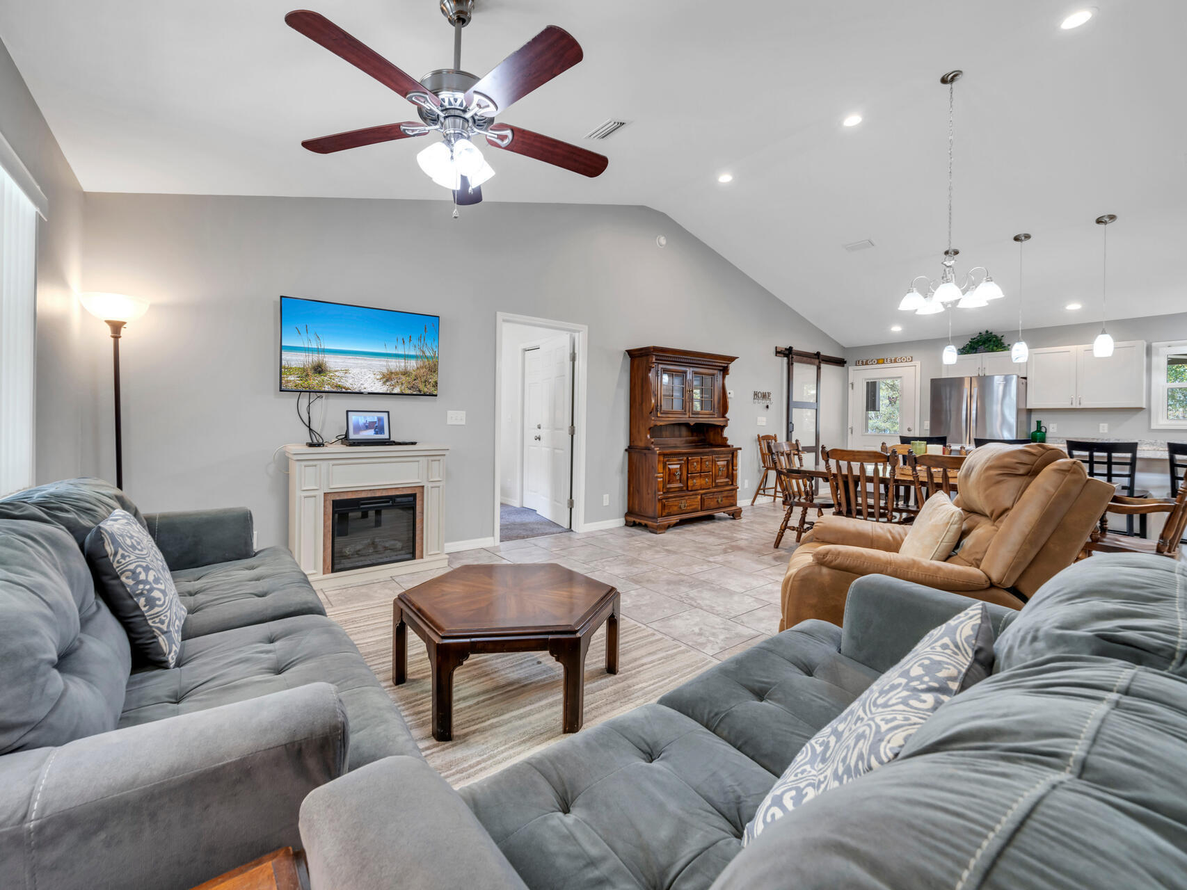 5346 Fox Hound Lane Baker, FL 32531 - Photo 18 of 46 a living room with furniture a fireplace and a chandelier