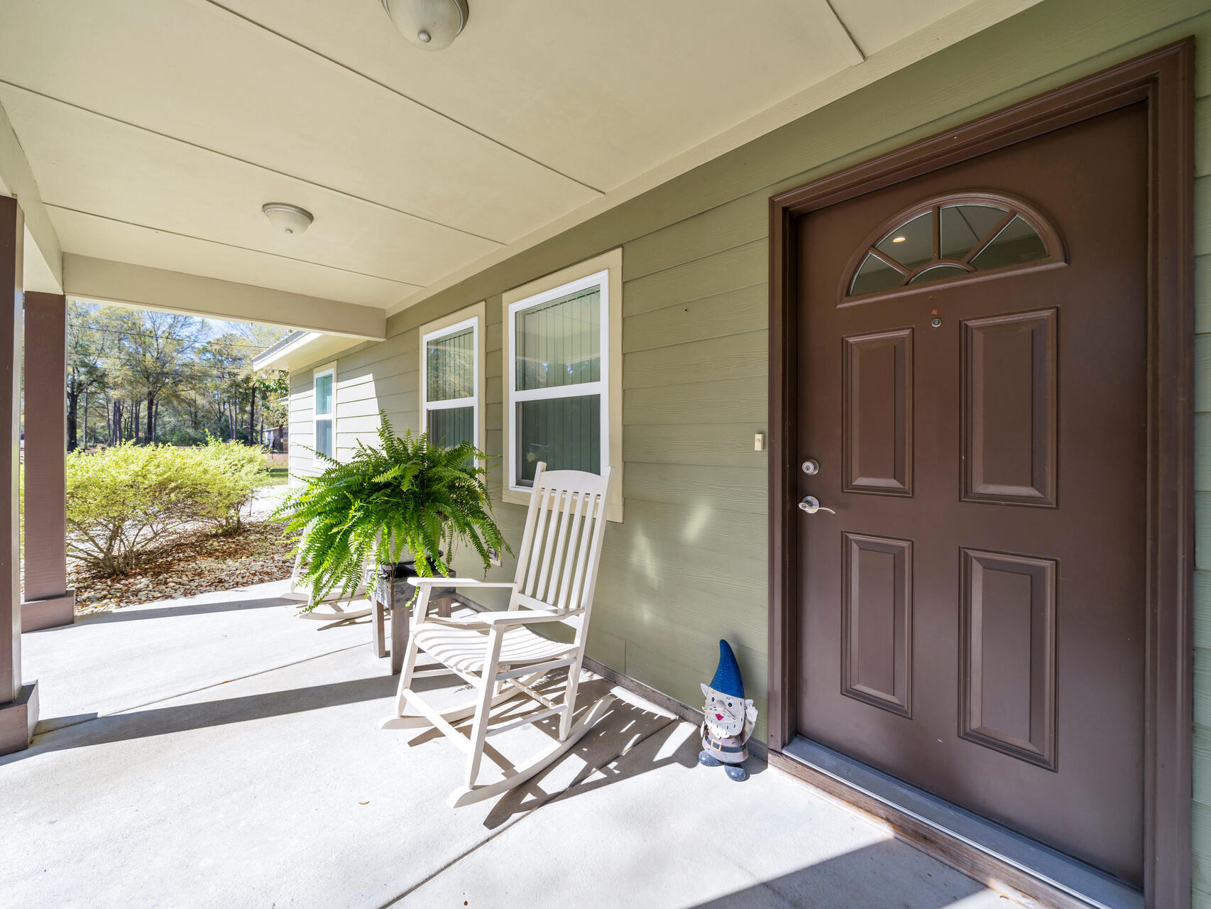 5346 Fox Hound Lane Baker, FL 32531 - Photo 8 of 46 a potted plant in front of a door