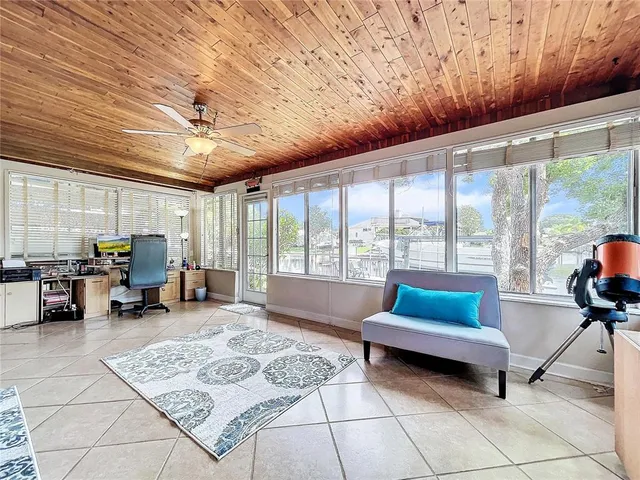 a living room with furniture and large windows