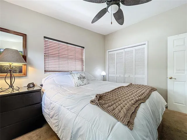 a bedroom with a bed and dresser with mirror