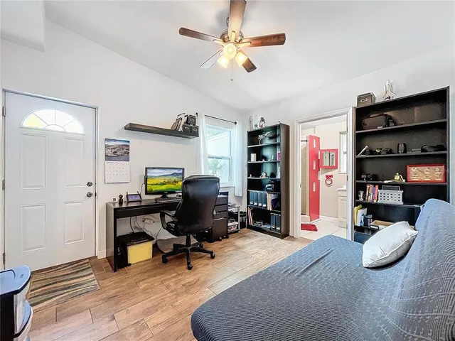 a view of a workspace with furniture and a window