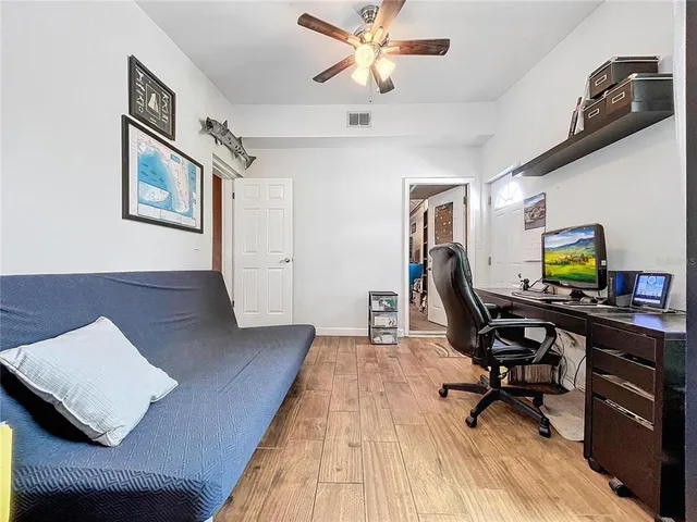 a living room with furniture a rug and a bookshelf