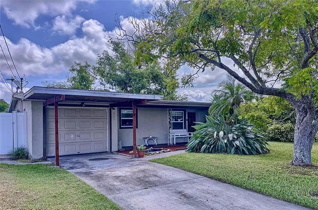 a front view of a house with a garden