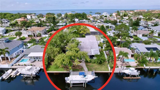 an aerial view of a house with a yard swimming pool and outdoor seating