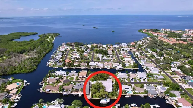 a view of a house with backyard porch and sitting area