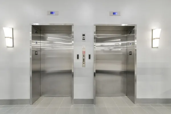 a kitchen with white cabinets and refrigerator