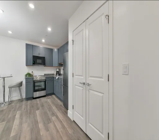 a kitchen with stainless steel appliances a refrigerator and a stove top oven