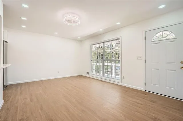 wooden floor in an empty room with a window