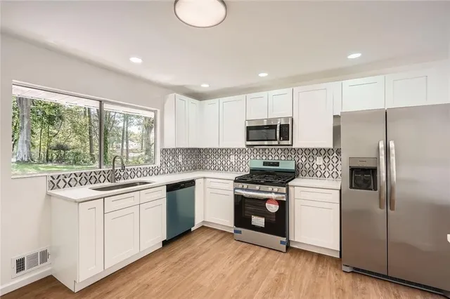 a kitchen with a sink stove and refrigerator