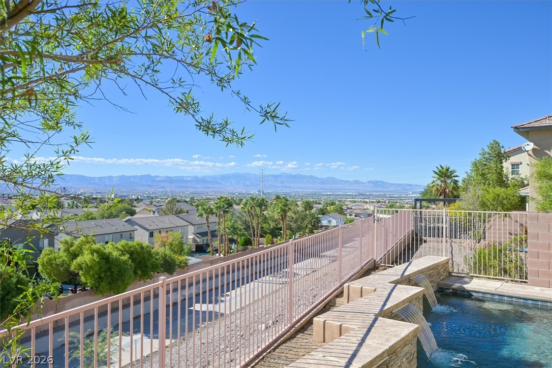 2447 Kaymin Ridge Road Henderson, NV 89052 - Photo 4 of 40 A sparkling pool with water features looks out over far-reaching valley and mountain vistas.