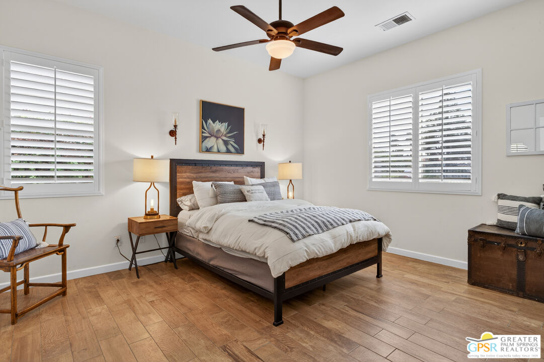 82717 Barrymore Street Indio, CA 92201 - Photo 12 of 26 a bedroom with a bed wooden floor and window