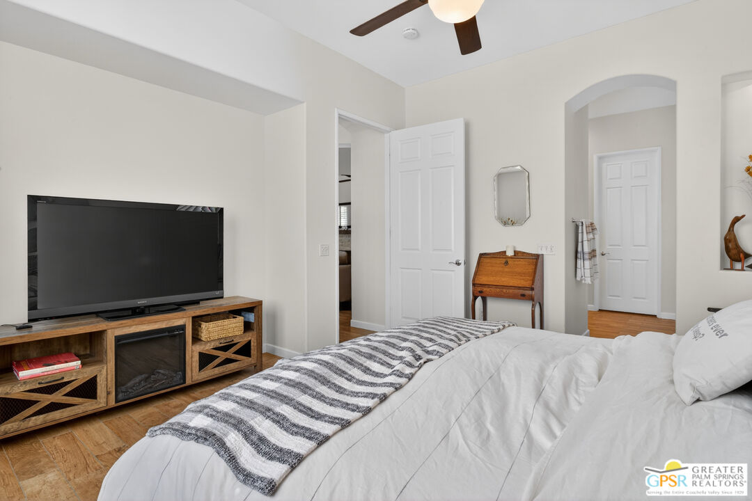 82717 Barrymore Street Indio, CA 92201 - Photo 13 of 26 a bedroom with a bed and a flat screen tv