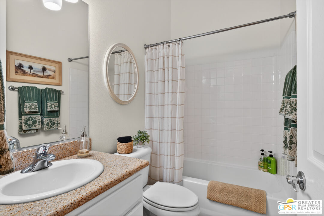 82717 Barrymore Street Indio, CA 92201 - Photo 17 of 26 a bathroom with a granite countertop sink toilet and shower