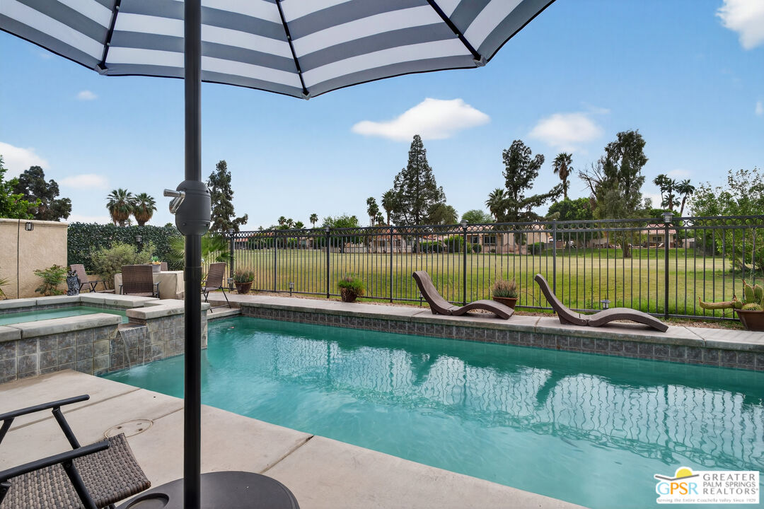 82717 Barrymore Street Indio, CA 92201 - Photo 18 of 26 a view of a swimming pool with a patio and a lake view