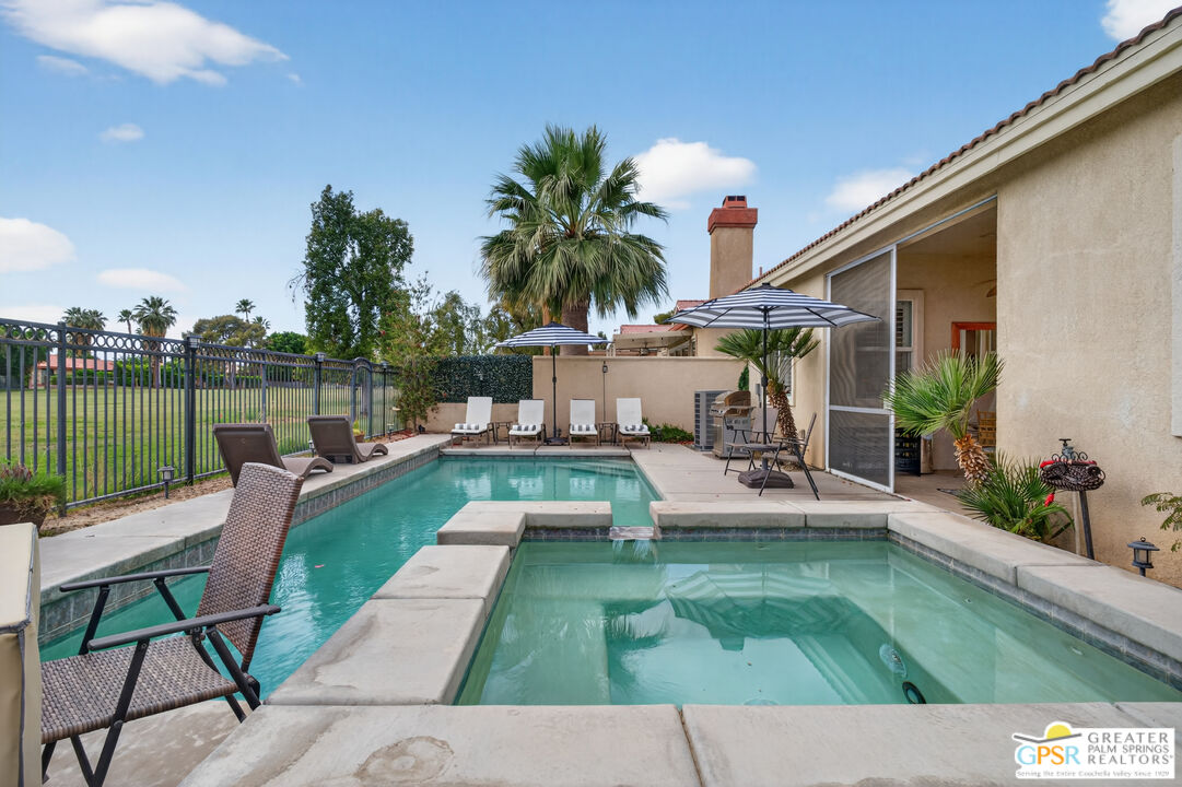 82717 Barrymore Street Indio, CA 92201 - Photo 22 of 26 a view of a swimming pool with lounge chairs