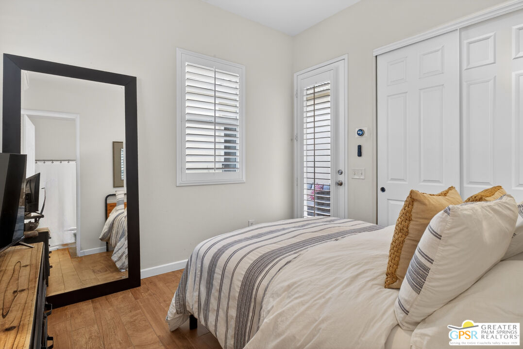 82717 Barrymore Street Indio, CA 92201 - Photo 24 of 26 a bedroom with a bed and a flat tv screen