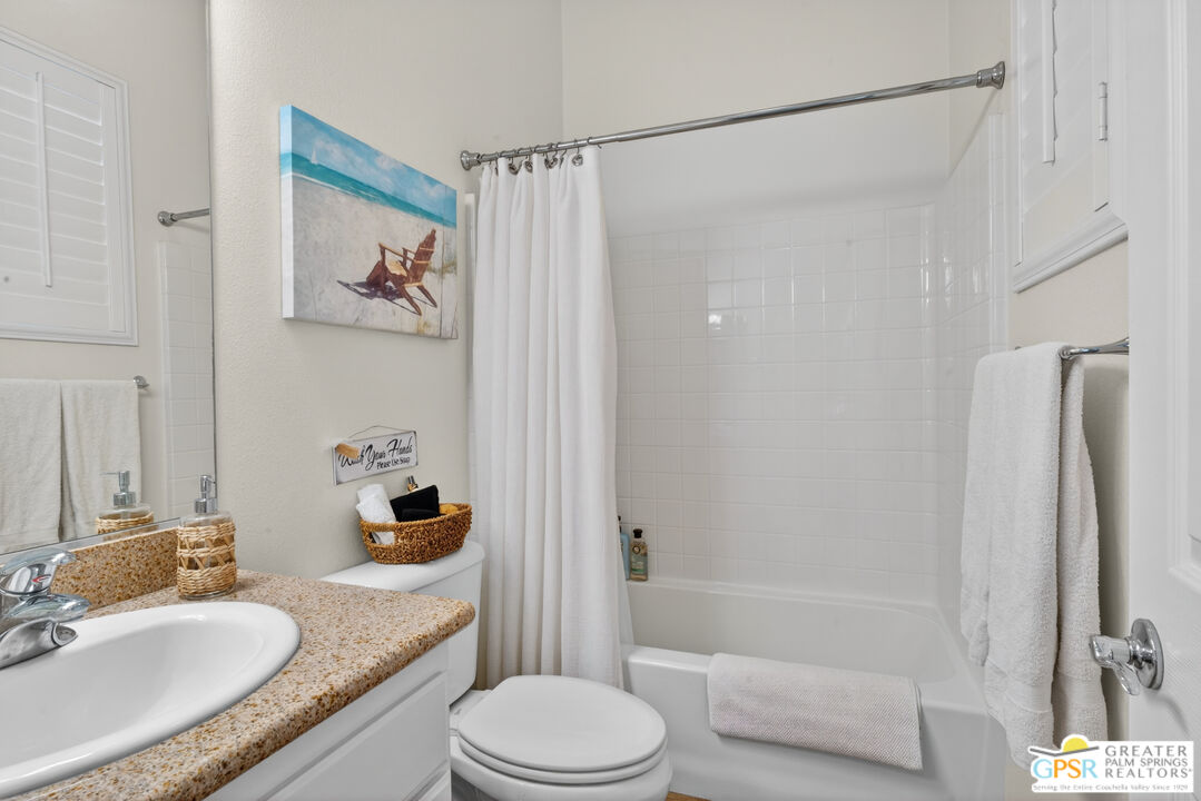 82717 Barrymore Street Indio, CA 92201 - Photo 25 of 26 a bathroom with a granite countertop sink toilet and shower