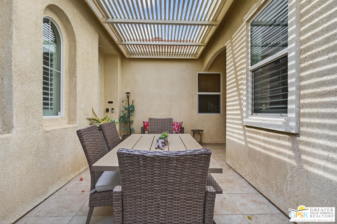 82717 Barrymore Street Indio, CA 92201 - Photo 4 of 26 a view of a patio with a table and chairs and potted plants