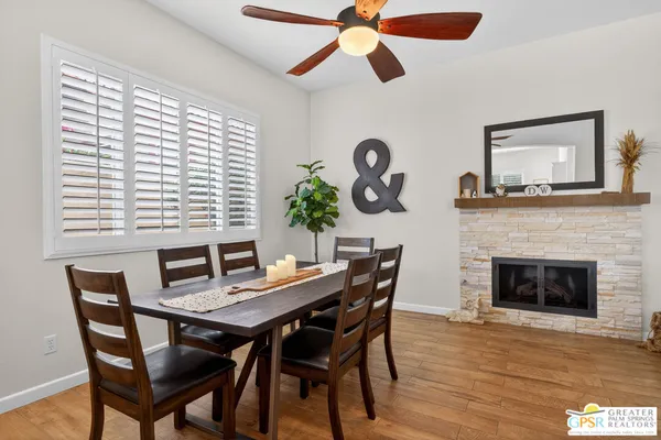 a view of a dining room with furniture and a large window