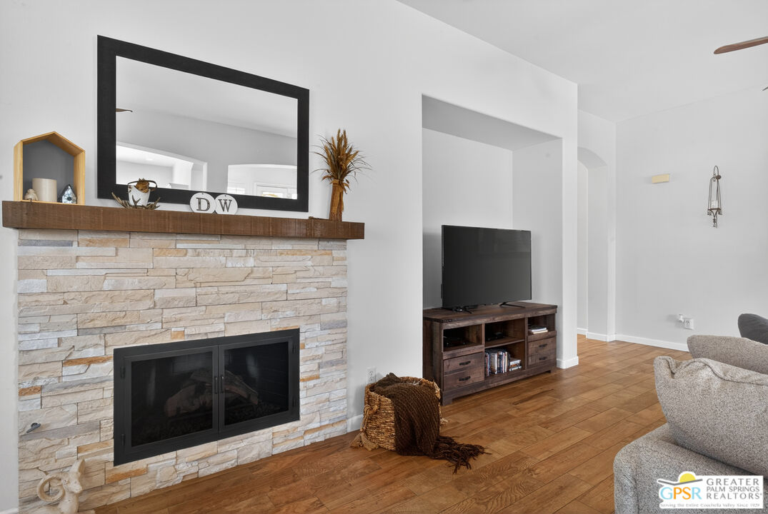 82717 Barrymore Street Indio, CA 92201 - Photo 9 of 26 a living room with furniture a flat screen tv and a fireplace