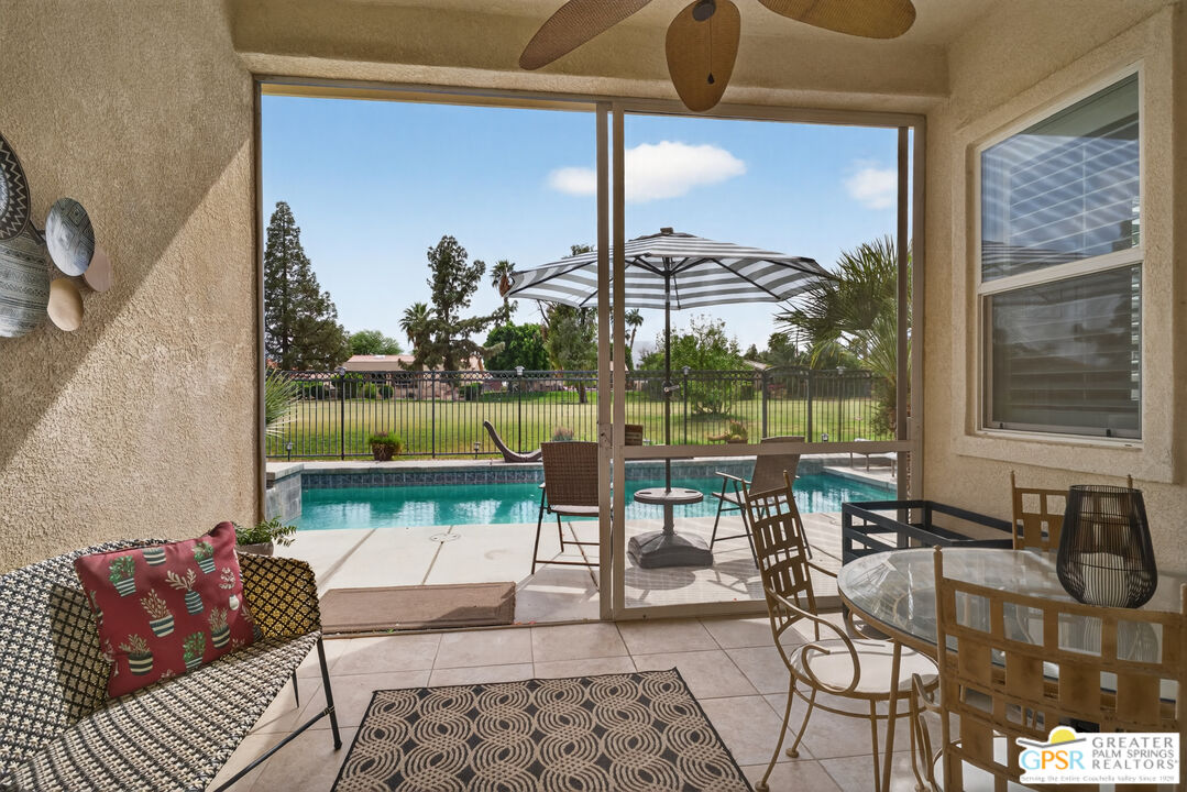 82717 Barrymore Street Indio, CA 92201 - Photo 10 of 26 a view of a patio with a dining table and chairs