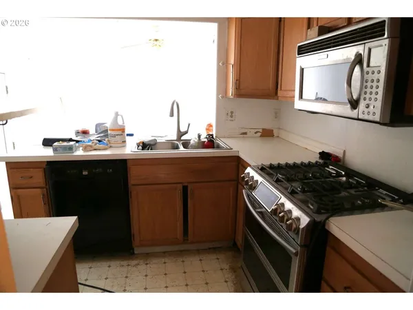 a kitchen view living space with furniture and floor to ceiling window