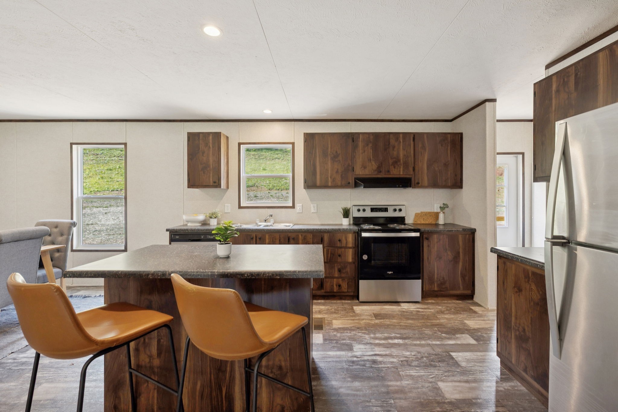 825 Gaulden Hollow Road Lafayette, TN 37083 - Photo 20 of 51 a kitchen with stainless steel appliances granite countertop a stove a refrigerator a sink a dining table and chairs