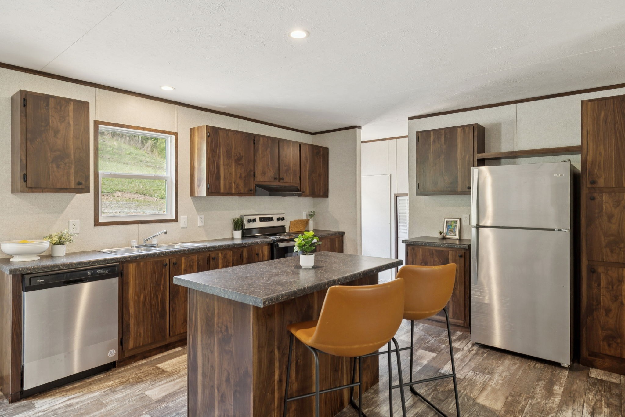825 Gaulden Hollow Road Lafayette, TN 37083 - Photo 39 of 51 a kitchen with stainless steel appliances granite countertop a refrigerator a sink a stove a dining table and chairs