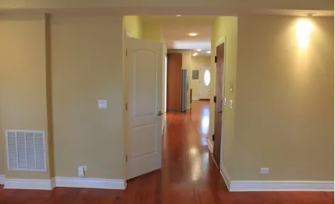 a view of a hallway with wooden floor