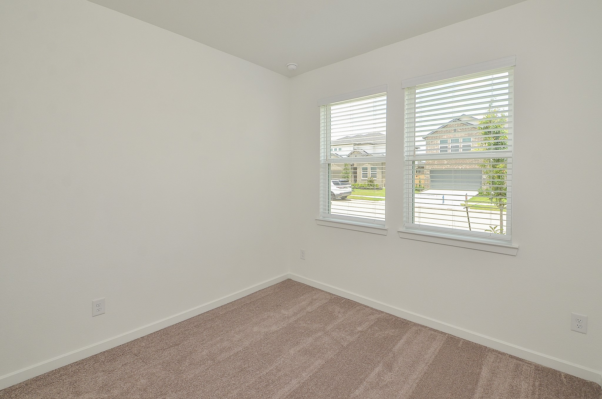 9727 Rialto Hts Drive Cypress, TX 77433 - Photo 27 of 37 Spacious bedroom with plush carpeting and recessed lighting. Features a tray ceiling and neutral walls, with a doorway leading to the ensuite bathroom.