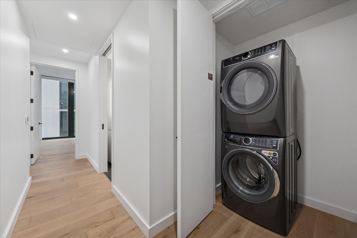 610 Davis Street, Unit 3005 Austin, TX 78701 - Photo 14 of 24 a view of a hallway with washer and dryer