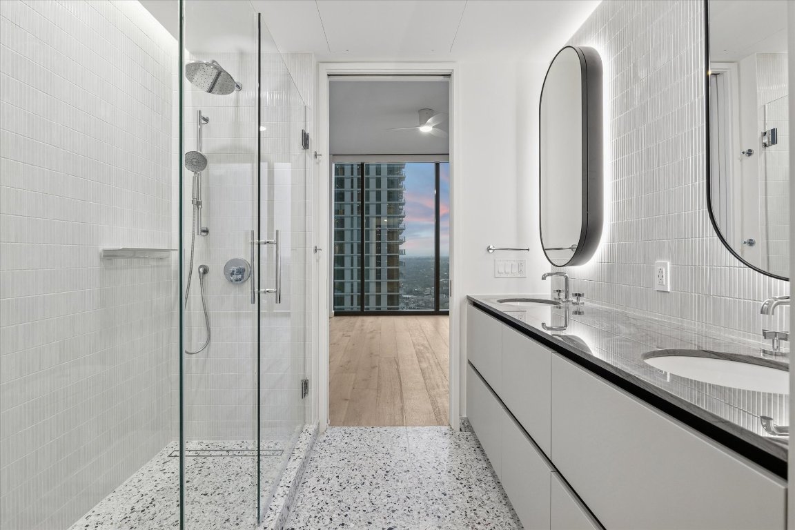 610 Davis Street, Unit 3005 Austin, TX 78701 - Photo 10 of 24 a en suite bathroom with a double vanity sink and mirror