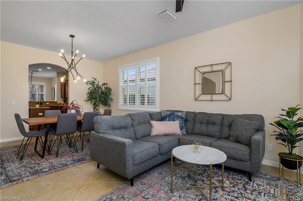 12454 Rock Ridge Lane Fort Myers, FL 33913 - Photo 13 of 37 a living room with furniture a chandelier and a window
