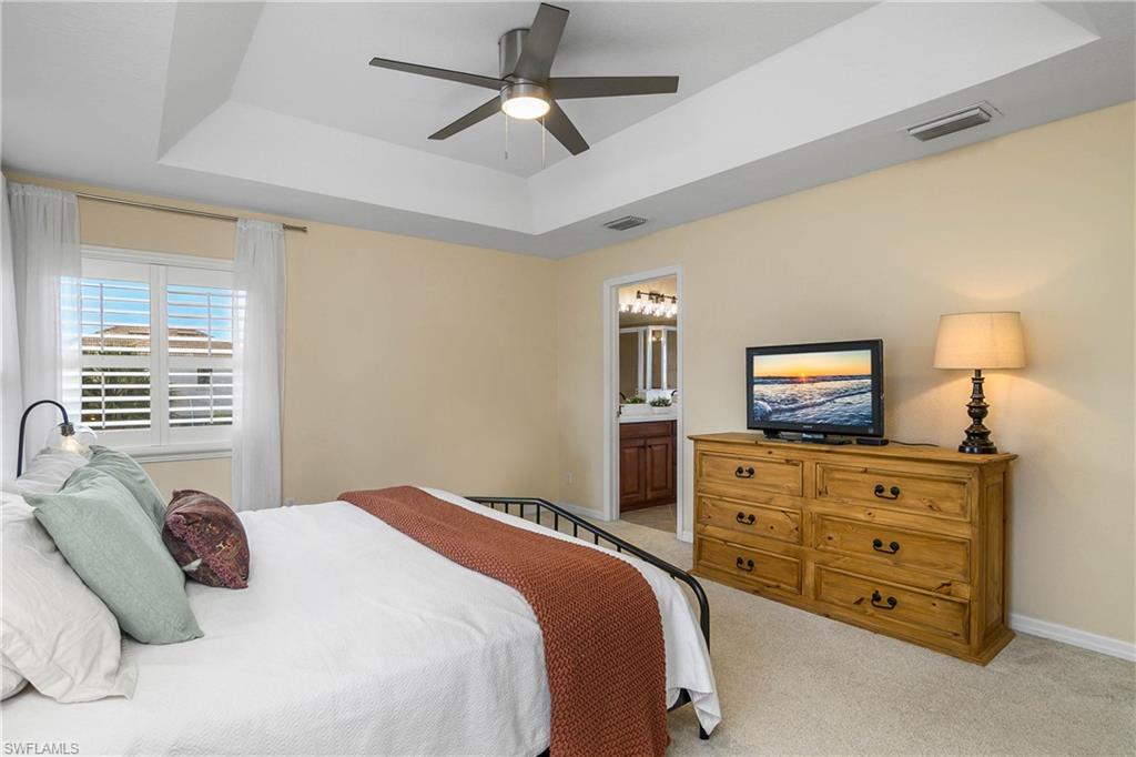 12454 Rock Ridge Lane Fort Myers, FL 33913 - Photo 15 of 37 a bedroom with a bed and a tv on dresser