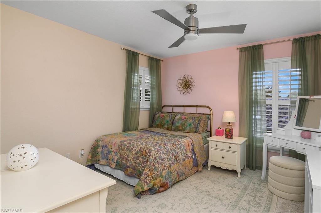 12454 Rock Ridge Lane Fort Myers, FL 33913 - Photo 19 of 37 a bedroom with a bed and a window