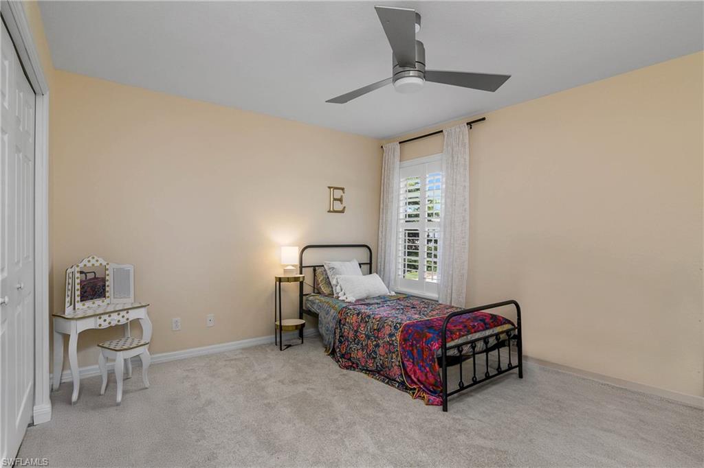 12454 Rock Ridge Lane Fort Myers, FL 33913 - Photo 20 of 37 a bedroom with a bed and a table in it