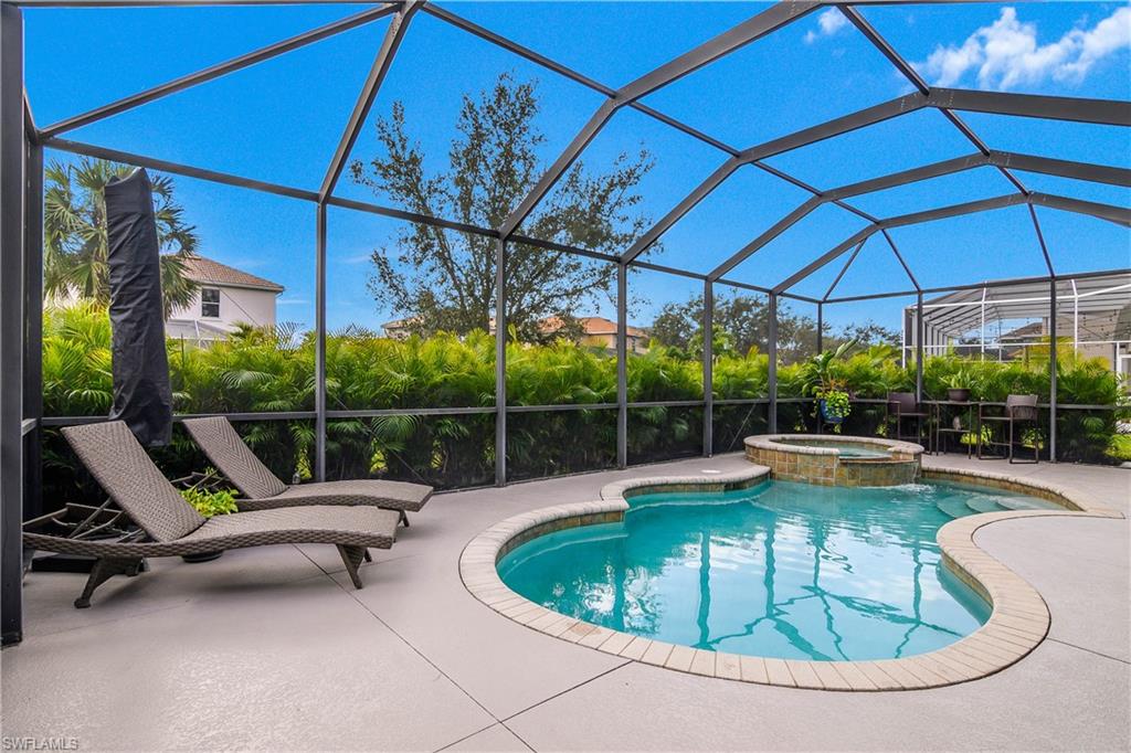12454 Rock Ridge Lane Fort Myers, FL 33913 - Photo 2 of 37 a view of a swimming pool with a lounge chair