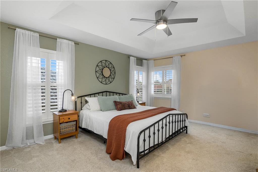 12454 Rock Ridge Lane Fort Myers, FL 33913 - Photo 5 of 37 a bedroom with a bed and a chandelier