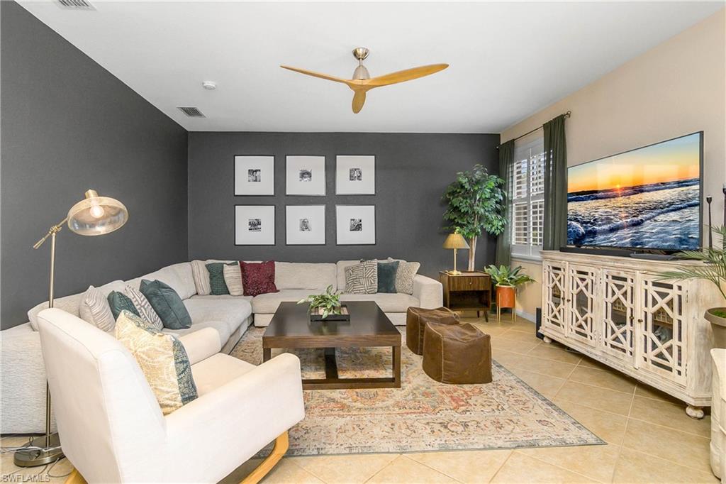 12454 Rock Ridge Lane Fort Myers, FL 33913 - Photo 10 of 37 a living room with furniture a floor to ceiling window and a flat screen tv