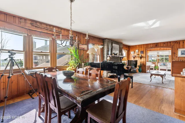 a view of a dining room with furniture and chandelier