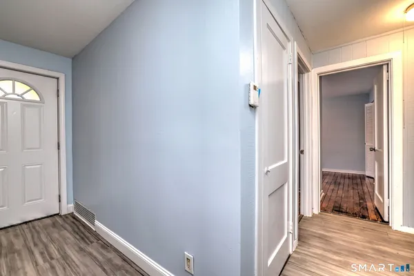 a view of a hallway with wooden floor