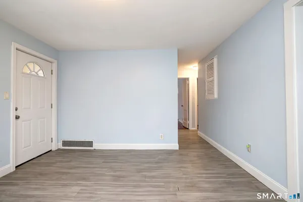 a view of an empty room and wooden floor