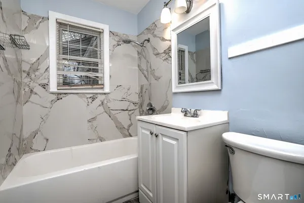 a bathroom with a sink a toilet and a bathtub