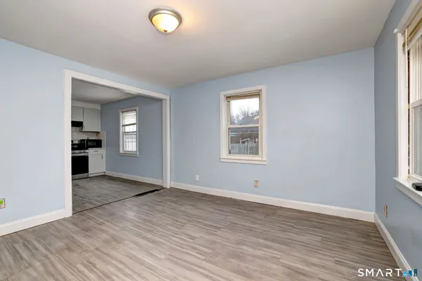 an empty room with windows and closet