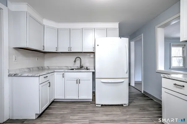 a white refrigerator freezer sitting inside of a kitchen