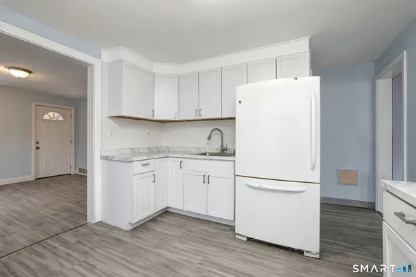 a white refrigerator freezer sitting inside of a kitchen