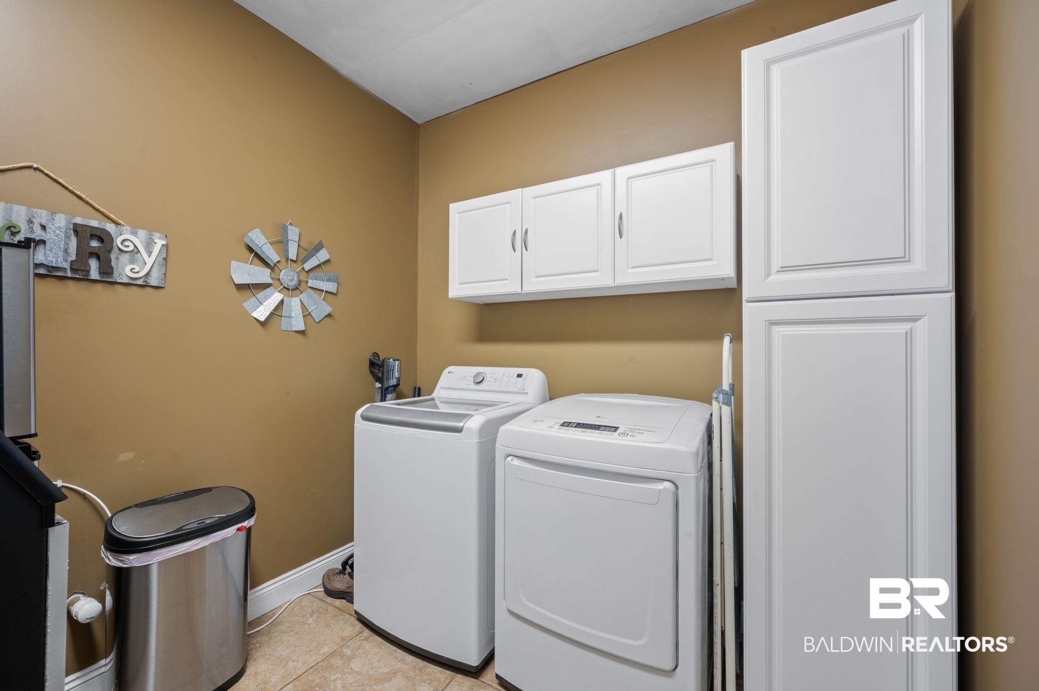 48513 Phillipsville Road Bay Minette, AL 36507 - Photo 16 of 50 Laundry area with cabinet space, washer and dryer, and light tile patterned floors
