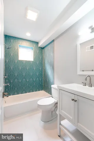 a bathroom with a bathtub and shower