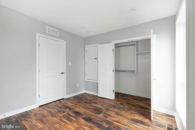 a walk in closet with white paint